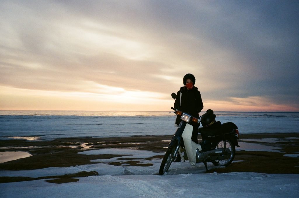 woman standing near motorcycle
