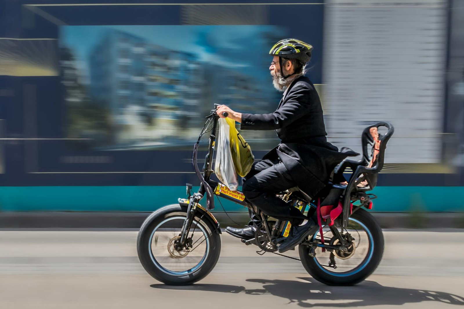 side view of a man riding an electric bicycle