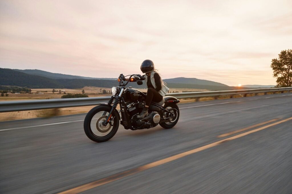 Photo by Harley-Davidson man on black cruiser motorcycle in highway